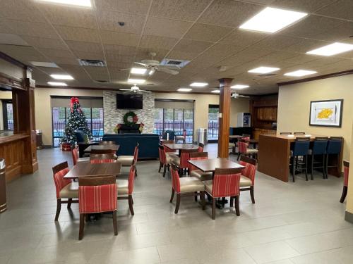 a dining room with tables and chairs and a christmas tree at Comfort Inn Pinehurst - Southern Pines in Pinehurst