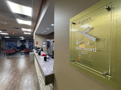 a door to a lobby with a sign on a wall at Comfort Inn Pinehurst - Southern Pines in Pinehurst