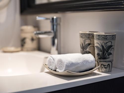 a plate of towels on a counter in a bathroom at The Flower Boutique Hotel & Travel in Hanoi