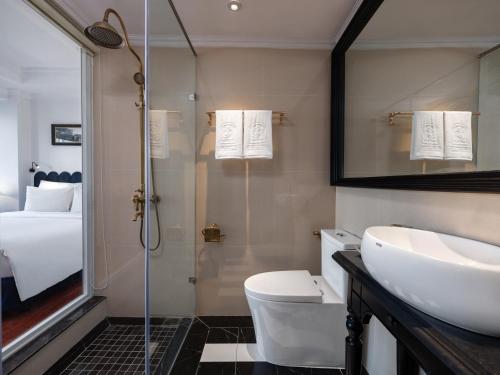 a bathroom with a sink and a toilet and a shower at The Flower Boutique Hotel & Travel in Hanoi
