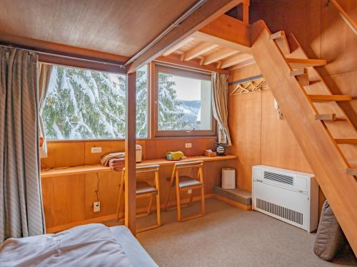 a bedroom with a bunk bed and a desk and a window at Lodge Scole in Zaō Onsen