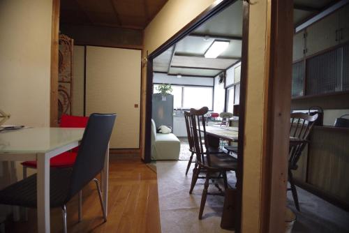 a dining room with a table and chairs at Villa Higashi Fujita Resort in Moroyose