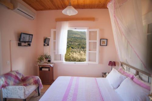 een slaapkamer met een bed en een raam bij Deep Blue- Rosemary sea view in Ayios Nikitas