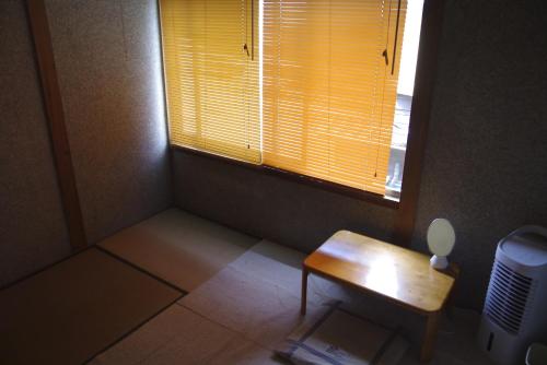 a small room with a table and a window at Annex higashifujita in Moroyose