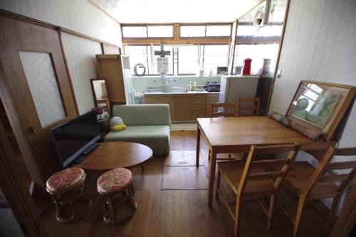 a living room with a couch and a table at Pavillon Higashi Fujita - an independent house in Moroyose