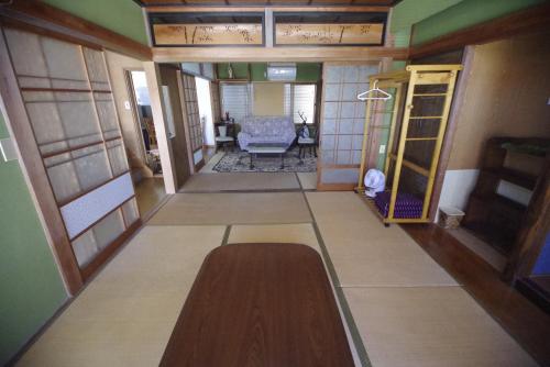 a hallway of a house with a room with a table at Pavillon Higashi Fujita - an independent house in Moroyose