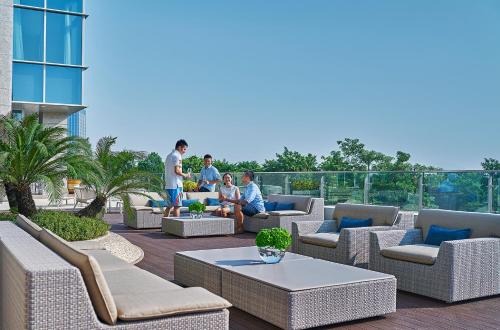 a group of people sitting on a rooftop patio at Shangri-La Xiamen - Seaside Hotel &Free Mini Bar in Xiamen