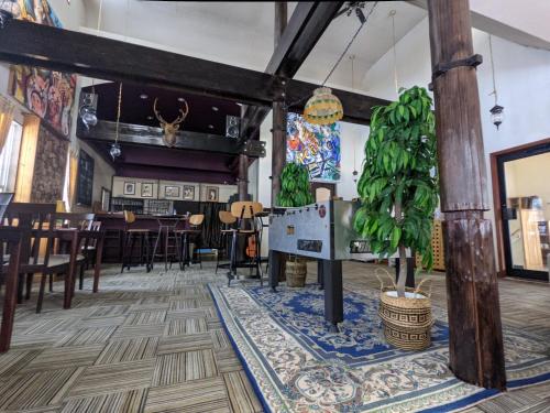 a dining room with a table and a plant in the middle at Luna Lodge in Hakuba