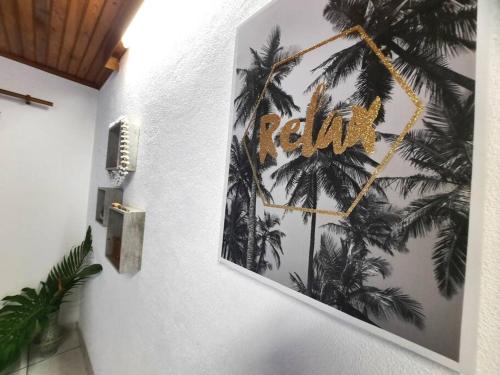 a wall with a picture of palm trees on it at Vacation house in Tahiti in Punaauia