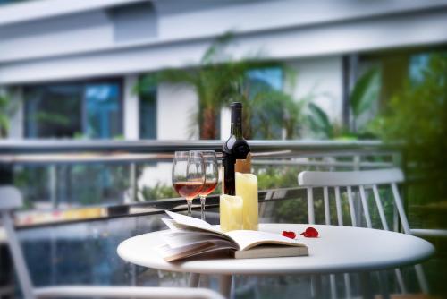 a table with a bottle of wine and a wine glass at Sky Garden Inn in Guilin