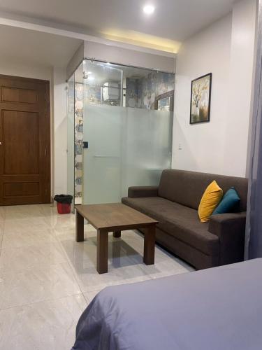 a living room with a couch and a coffee table at Qhome in Ho Chi Minh City