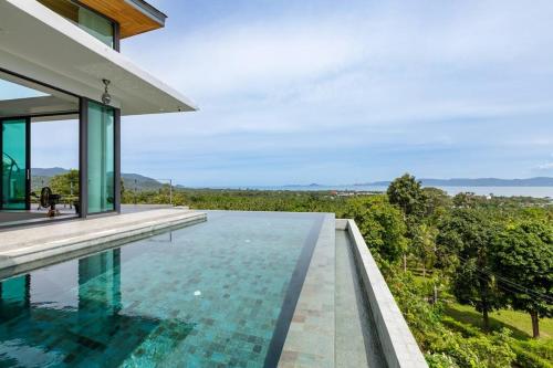 an infinity pool in a house with a view at Stunning SeaView Pool Villa in Haad Pleayleam
