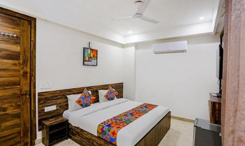a bedroom with a bed in a room at FabHotel Amrit Grand in Gurgaon