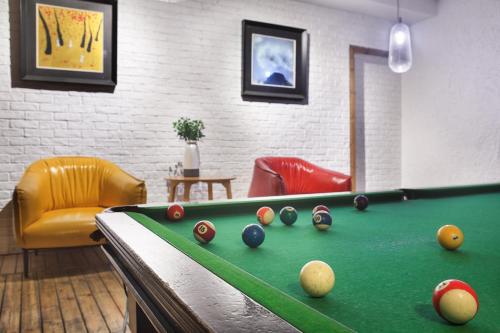 a room with a pool table with balls on it at Sky Garden Inn in Guilin