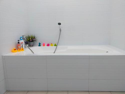 a white bathroom with a white bath tub at D'Port DicksonMuslimOnly Homestay in Port Dickson