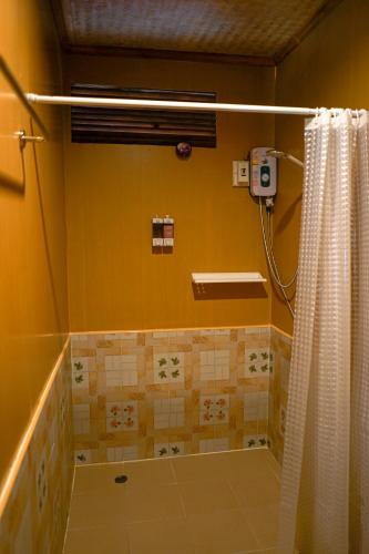 a bathroom with a shower with a shower curtain at Pai Homey in Pai