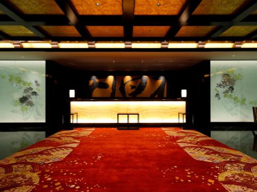 a red carpet on a bed in a room at THE HOTEL SANRAKU KANAZAWA 21th December 2022 OPEN in Kanazawa