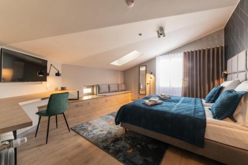 a bedroom with a bed and a desk and a chair at MILU Apartments Sebastiana in Krakow