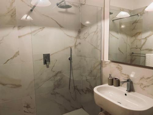 a bathroom with a shower and a sink and a mirror at Donoratico Comfort and Relax on the Etruscan Coast in Donoratico