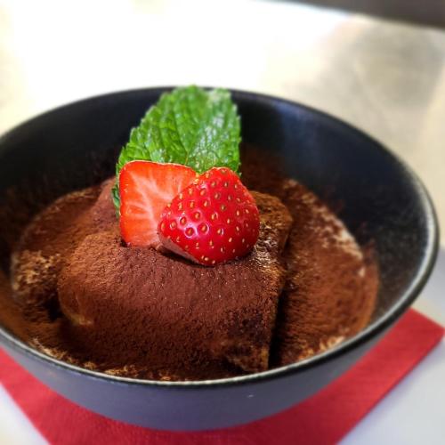 a chocolate dessert with strawberries on top of it at Hotel-Restaurant Eyholz in Visp