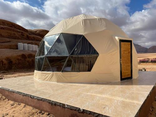 a dome tent in the middle of the desert at Bronze Mountains Camp Wadi Rum in Aqaba