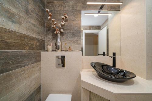 baño con lavabo negro en la encimera en Casa Camila Family bungalow, en Alfaz del Pi