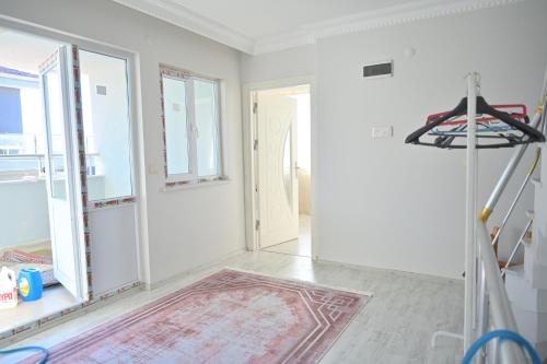 a white room with a door and a rug at Forest villa- 5 minutes from the airport in Arnavutköy