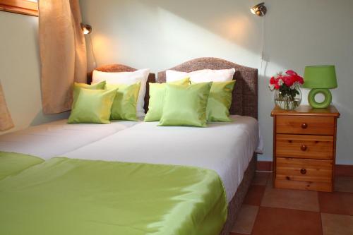 a bedroom with two beds with green pillows at Apartments Villa Milna 1 in Budva