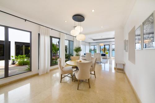 a dining room with a table and chairs at Maison Privee - 5 Stars Villa with Private Pool or Beach on Palm Jumeirah in Dubai