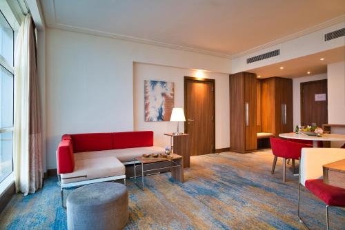 a living room with a couch and a table at Novotel Jazan in Jazan