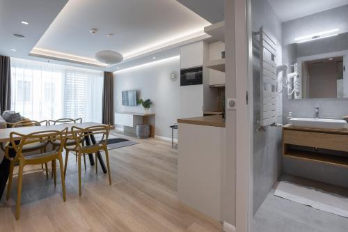a kitchen and dining room with a table and chairs at K46 Residence in Budapest