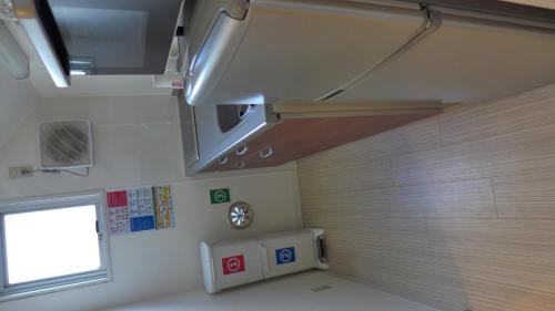 een kleine kamer met een raam en verwarming bij Isshuku Ryokan Asakusabashi - Vacation STAY 17363v in Tokyo