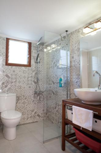 a bathroom with a toilet and a sink and a shower at Villa close to the beach in Nea Potidaea