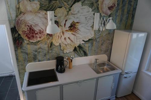 a kitchen with a sink and a refrigerator at Rosalinde in Lüneburg