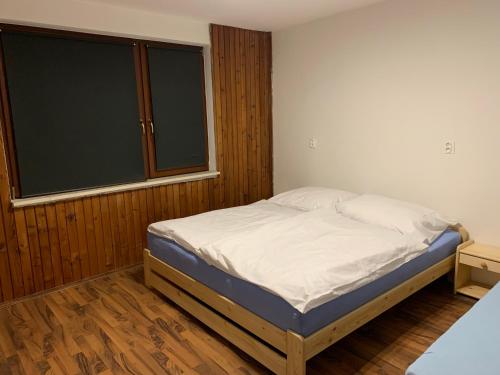 a bedroom with a bed and a large window at Bystravilla in Bystrá