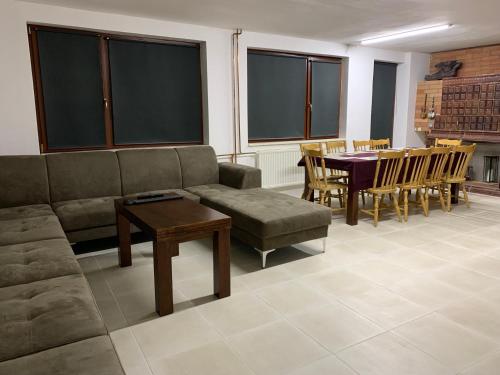 a living room with a couch and a table and chairs at Bystravilla in Bystrá