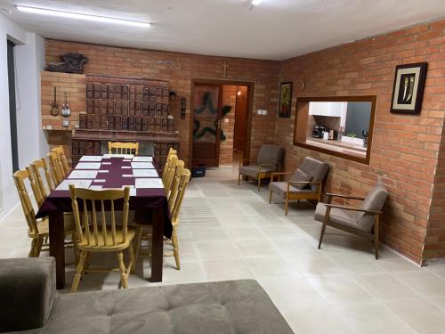 a dining room with a table and chairs and a brick wall at Bystravilla in Bystrá