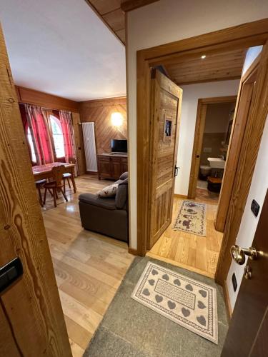 an open door to a living room with a couch at Casa Olivera in Limone Piemonte