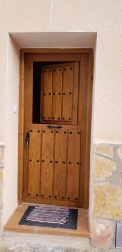 a large wooden door in the side of a building at CASA La Playeta in Puente de Vadillos