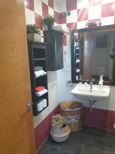 a bathroom with a sink and a mirror at ATICO CINE COLON 3 in Ribadeo