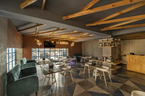 a restaurant with tables and chairs in a room at Zostel Hyderabad in Hyderabad