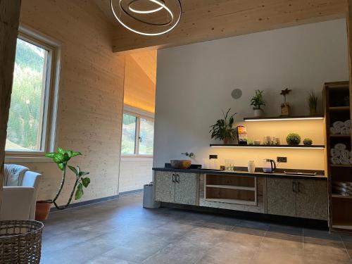 a kitchen with a sink and a counter in a room at Pension Alpenperle in Holzgau