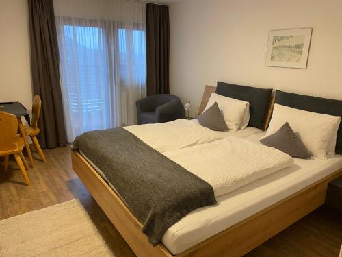 a bedroom with a large bed in a room at Pension Aschlandhof in Obsteig