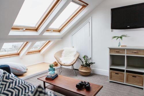 a loft conversion with skylights and a living room at Highcliffe in Falmouth