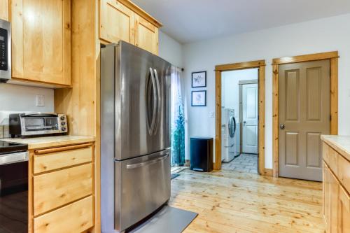 a kitchen with a stainless steel refrigerator and wooden cabinets at Oak Street Retreat in Sisters