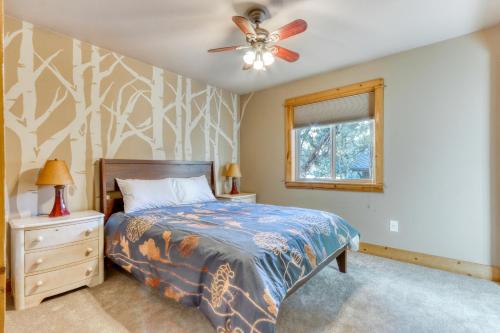 a bedroom with a bed and a ceiling fan at Oak Street Retreat in Sisters