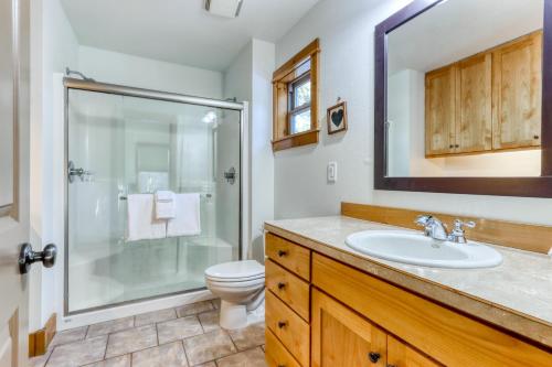 a bathroom with a shower and a sink and a toilet at Oak Street Retreat in Sisters