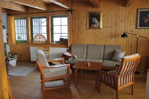 a living room with a couch and chairs and a table at Ferienhaus Schellerhäusl in Kurort Altenberg
