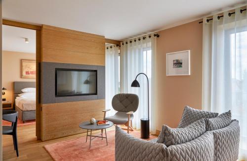a living room with a couch and a tv at PURO Gdańsk Stare Miasto in Gdańsk