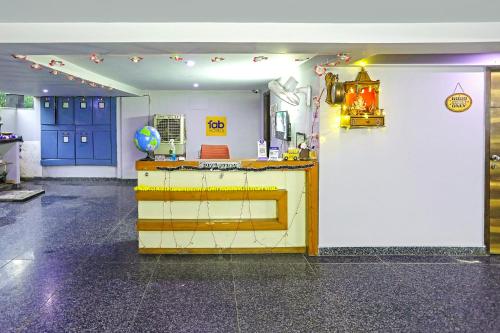 a room with a counter and blue doors at FabHotel White House BNB in New Delhi